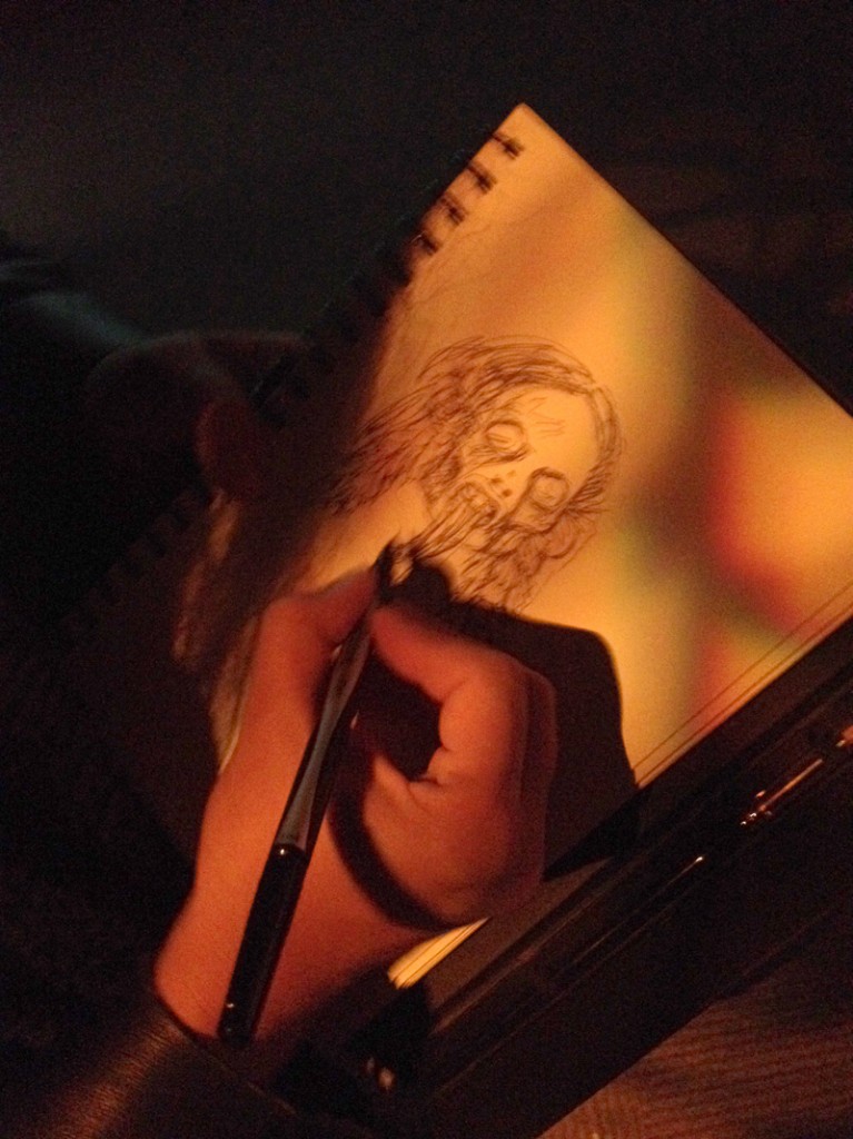 Christina draws a shrunken head.
